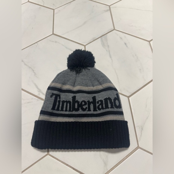 TIMBERLAND GRAY BLACK LOGO CUFFED BEANIE HAT WITH POM UNISEX ONE SIZE - Picture 1 of 4